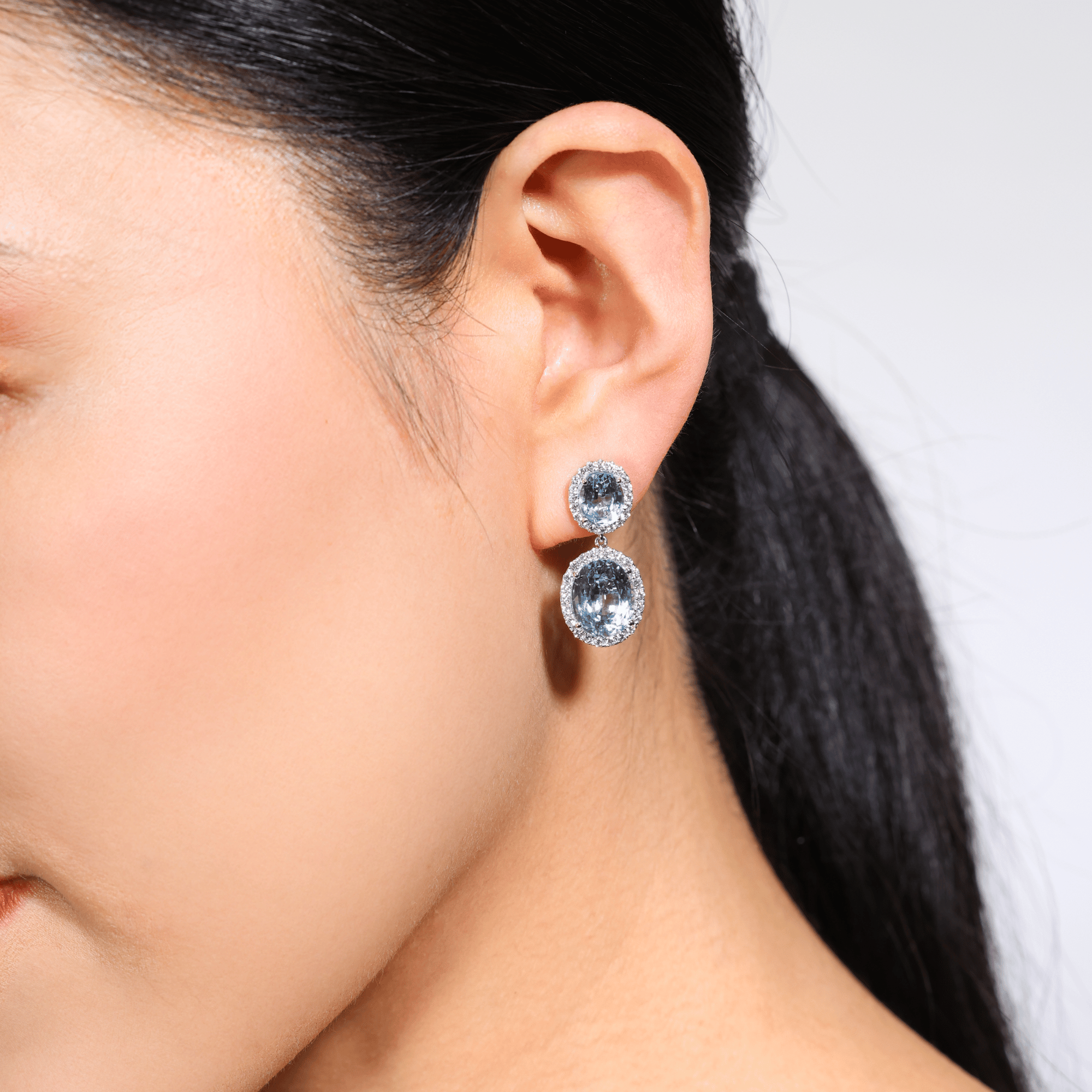 Sky blue oval cut topaz and diamond drop earrings